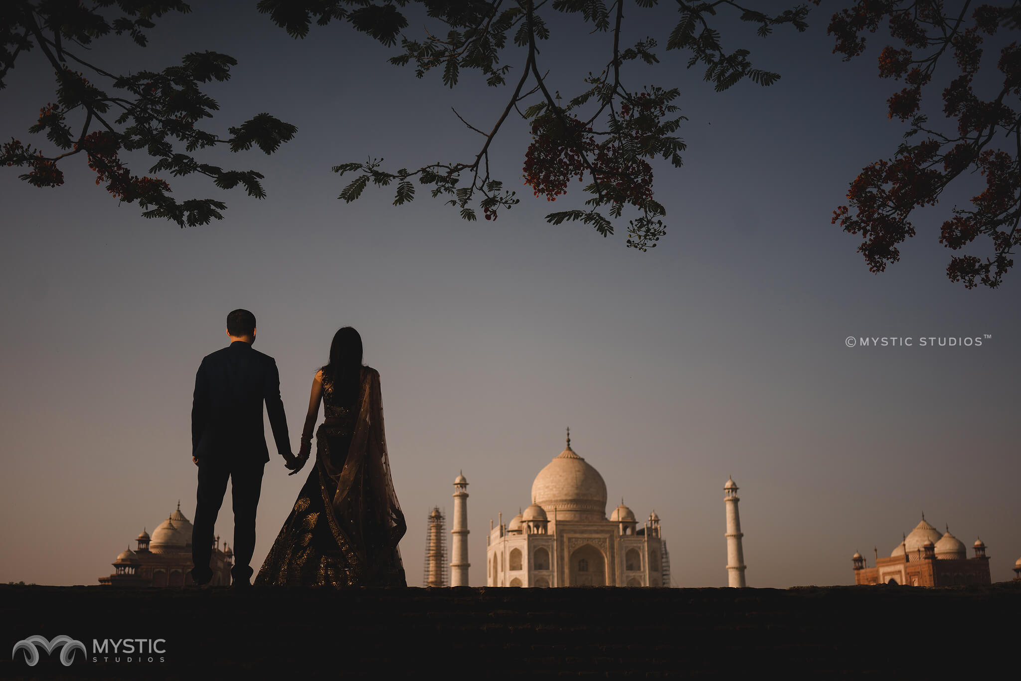 My friend at Taj Mahal. Can someone remove the people in the background,  add some natural color to the sky (maybe clouds) and perhaps sharpen/adjust  other colors (building.) Happy to tip! Thank