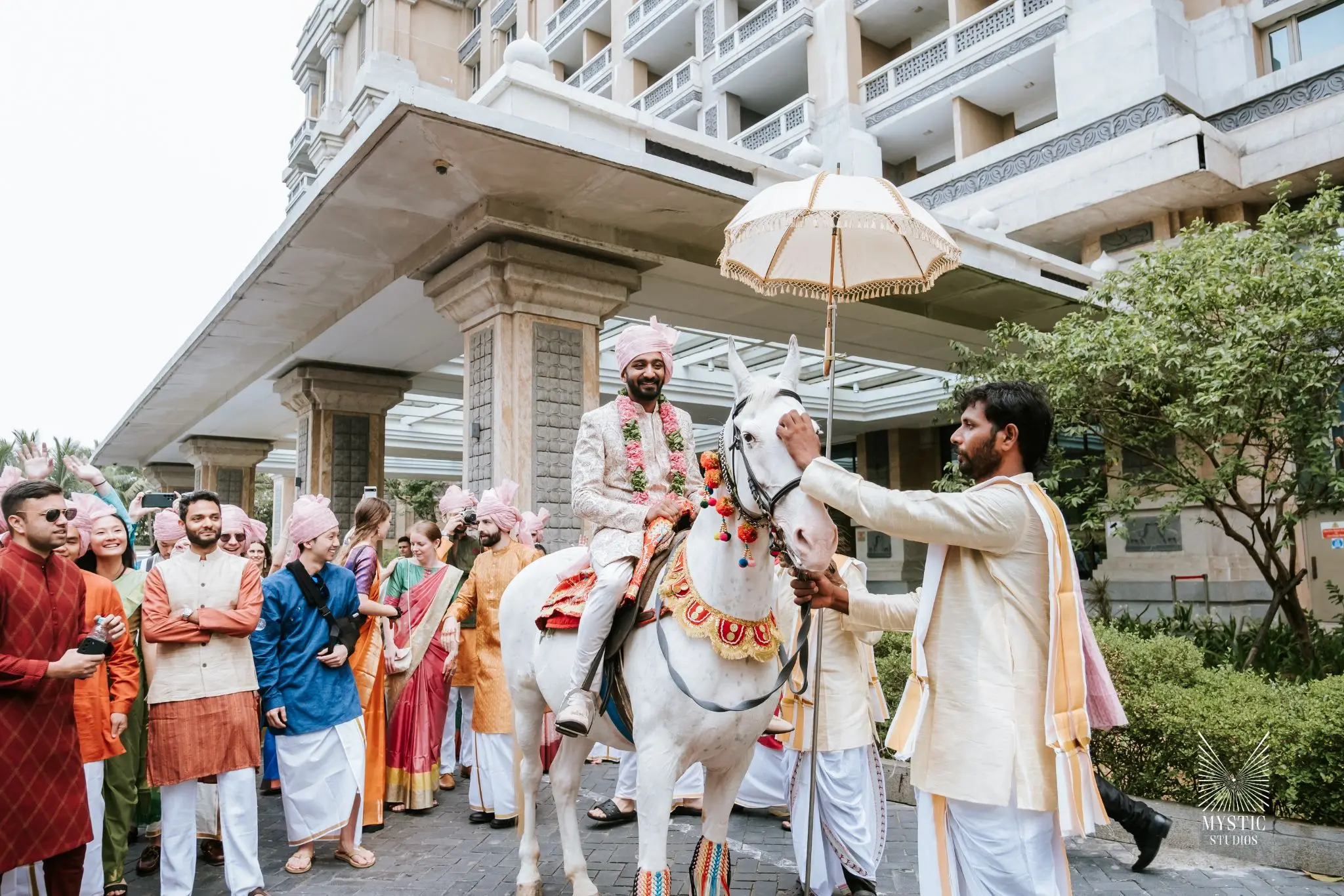 Luxury wedding in ITC Grand chola baraat ceremony photographed in candid elegance by Mystic Studios.