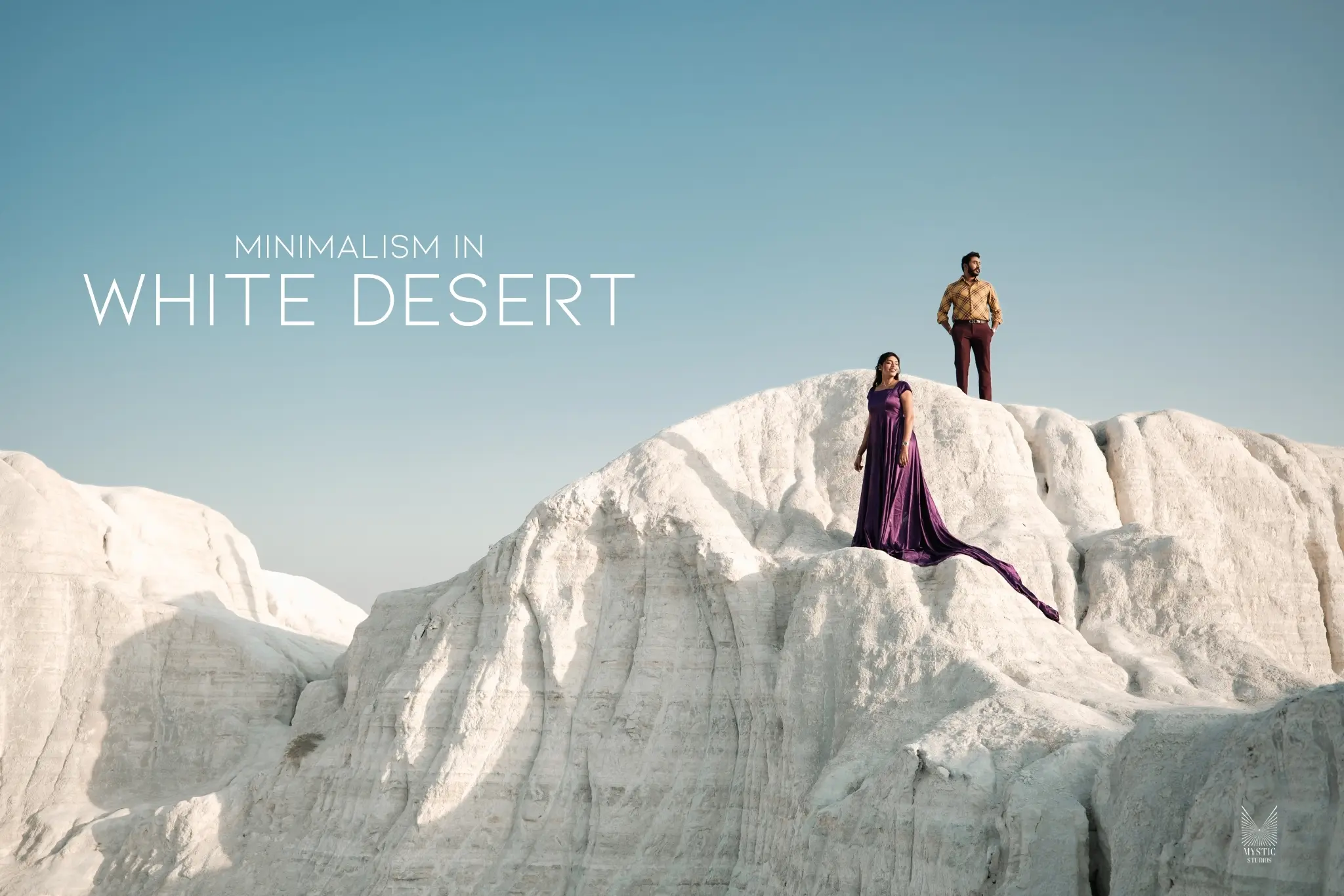 Elegant pre-wedding couple shoot in vast white desert landscape.